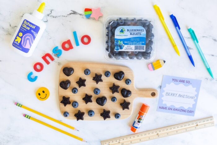 Back-to-school scene with Consalo Blueberries, homemade blueberry gummies, and colorful school supplies.