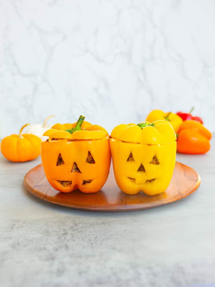 Jack O'Lantern peppers stuffed with meat and cheese.