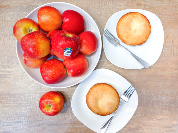 Mini Apple Pies made and Kanzi Apples on a ceramic bowl